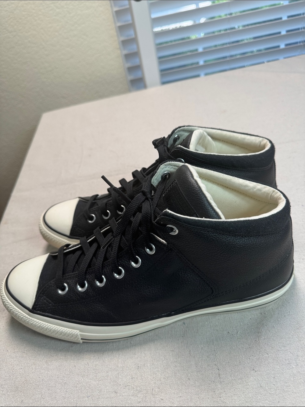 Converse All Star Black Leather White Low-Top Sneaker with Black Details.